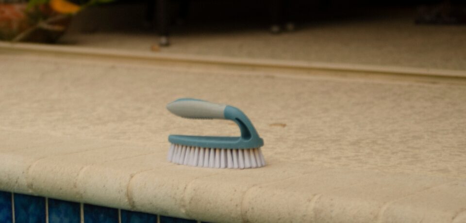 A,Close-up,Image,Of,A,Handheld,Scrub,Brush,With,White