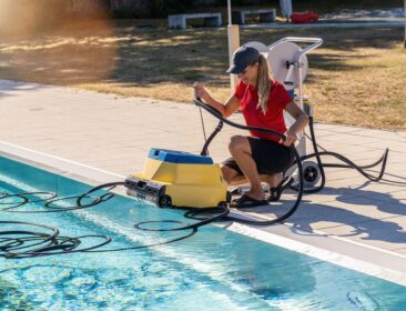 Pool,Technician,Crouching,By,A,Pool,,Handling,A,Robotic,Pool